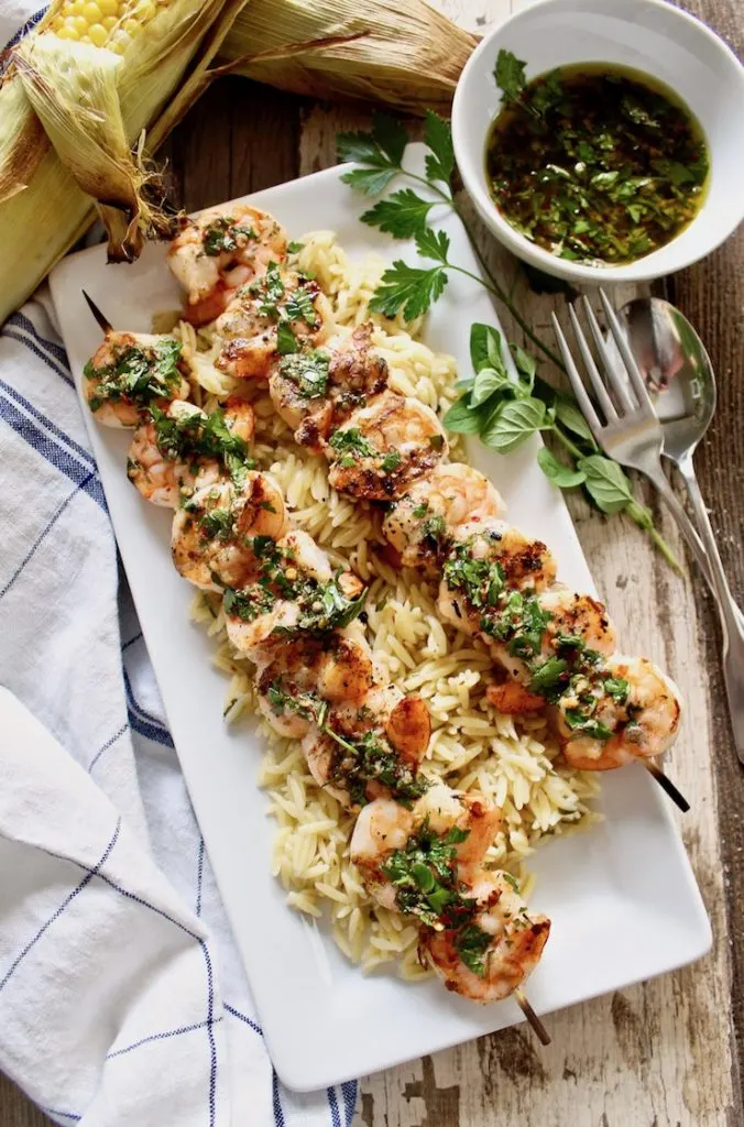 Grilled Shrimp with Chimichurri Sauce on platter with orzo.