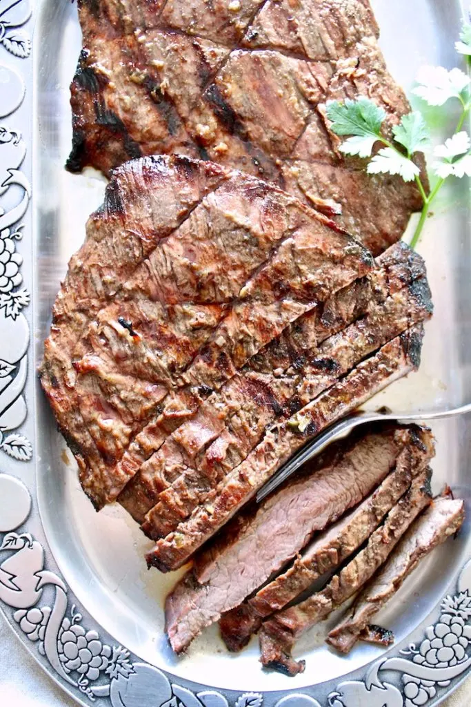Marinated Grilled Flank Steak on serving platter.