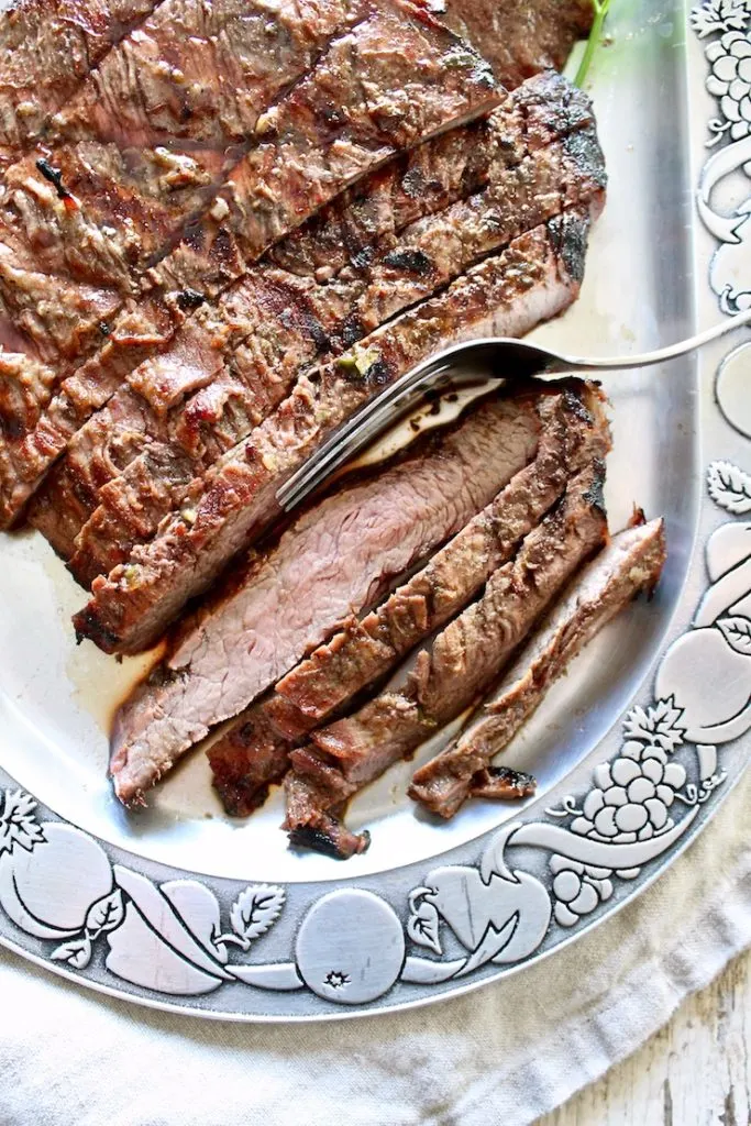 Close up of flank steak slices on platter.