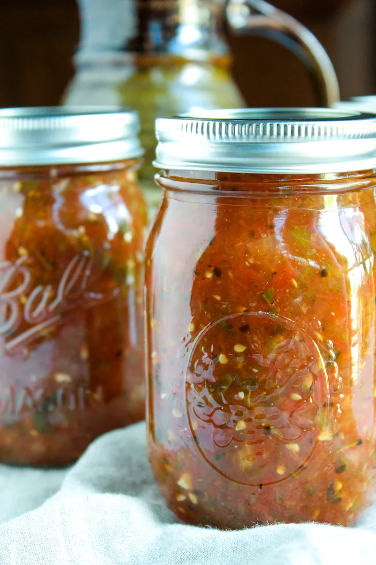 Up close jars of fire roasted salsa.