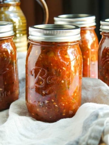 Jars of canned fire roasted salsa.