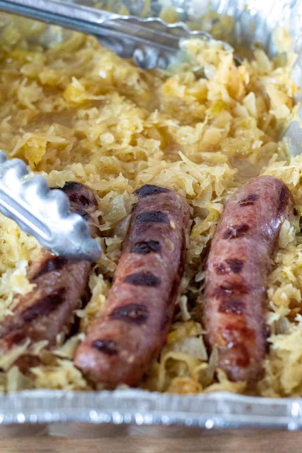 Beer Brats And Sauerkraut Cooked On The Grill In One Pan 