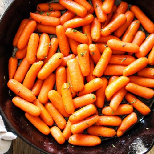 Baby carrots in cast iron pan.