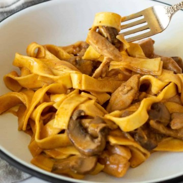 Plate of chicken stroganoff with forkful.