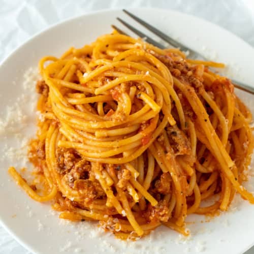Spaghetti swirled on white serving plate