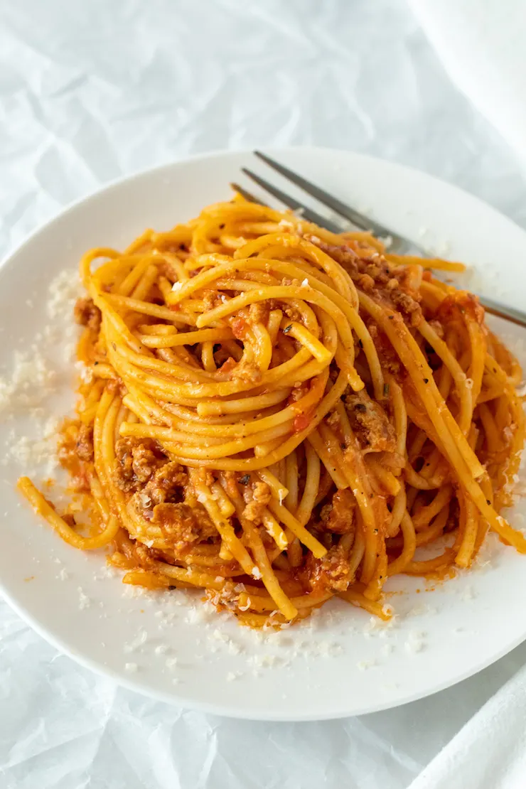 Spaghetti swirled on white serving plate