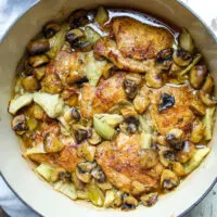 Overhead photo of chicken and artichokes with sherry mushroom sauce.