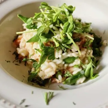 Finished risotto in bowl with fresh herbs.