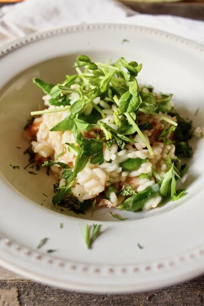 Finished risotto in bowl with fresh herbs.