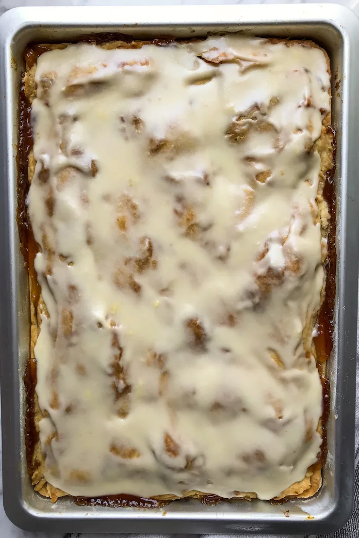 Overhead of glazed apple slices in pan