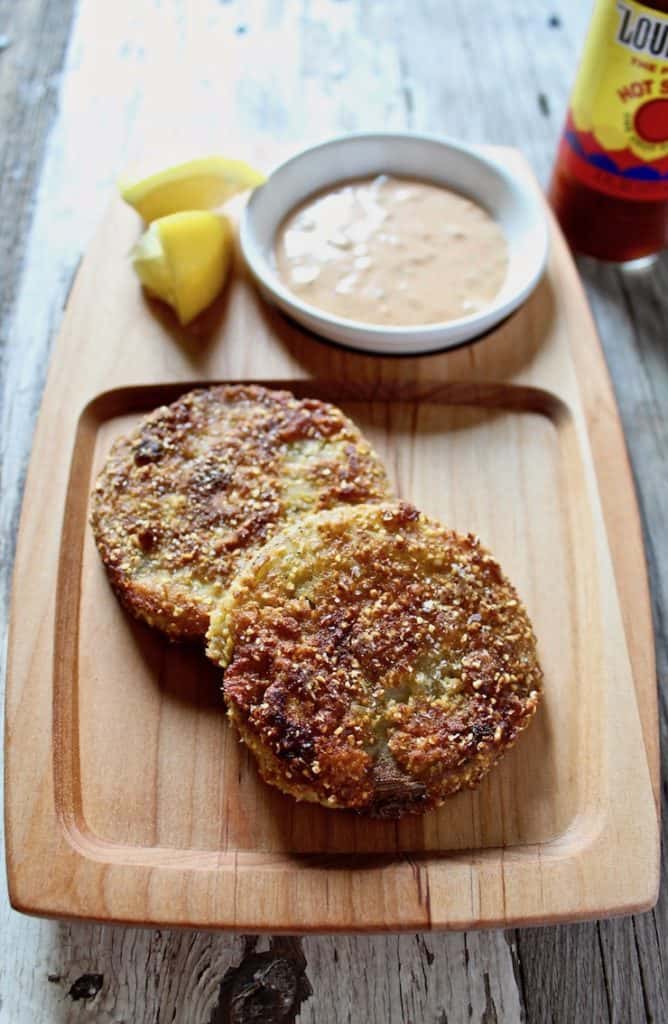 Fried green tomatoes on wooden serving board with remoulade sauce