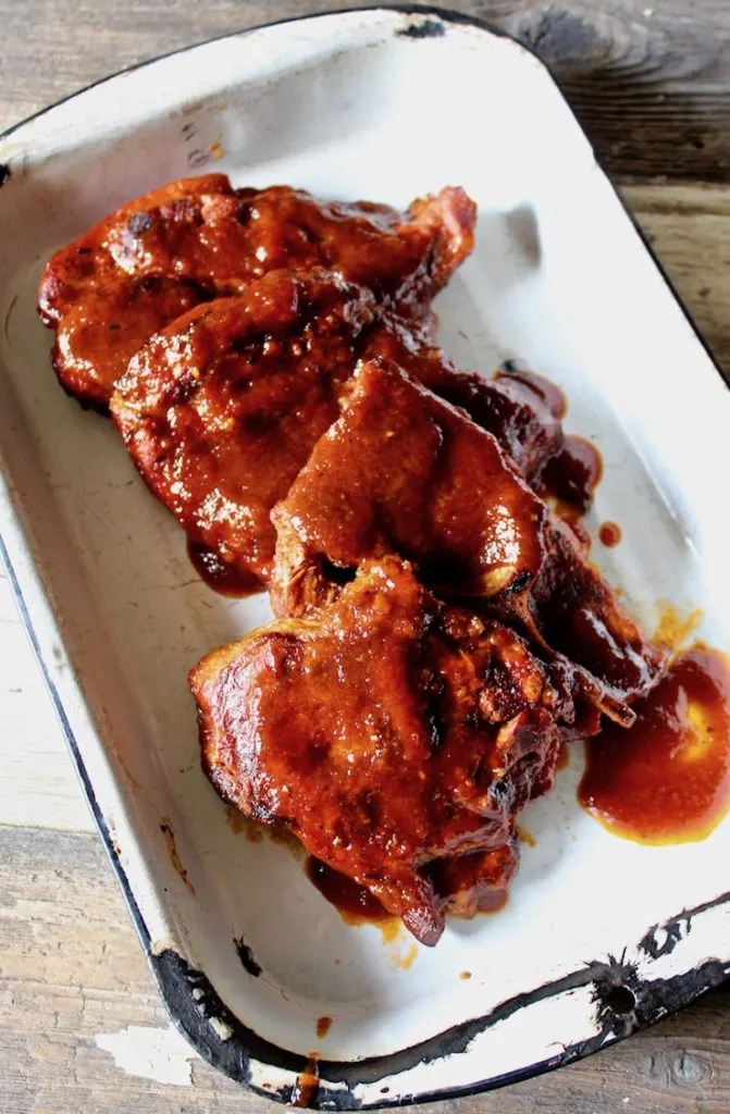 St. Louis BBQ Pork Steaks overhead shot in pan with sauce.