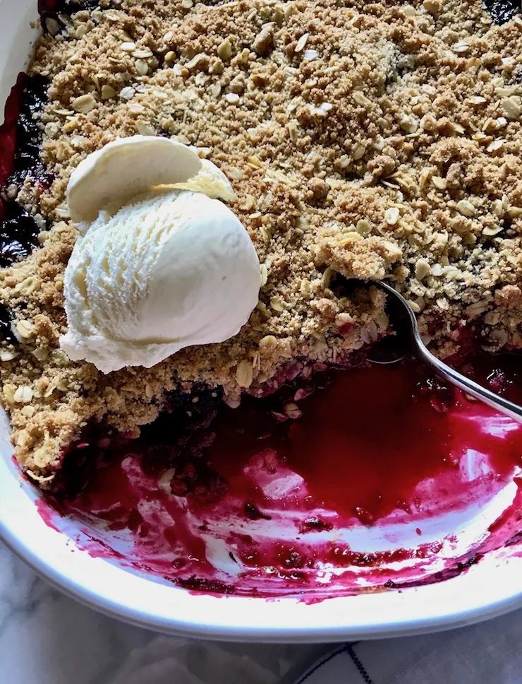 In baking dish with ice cream and spoon.