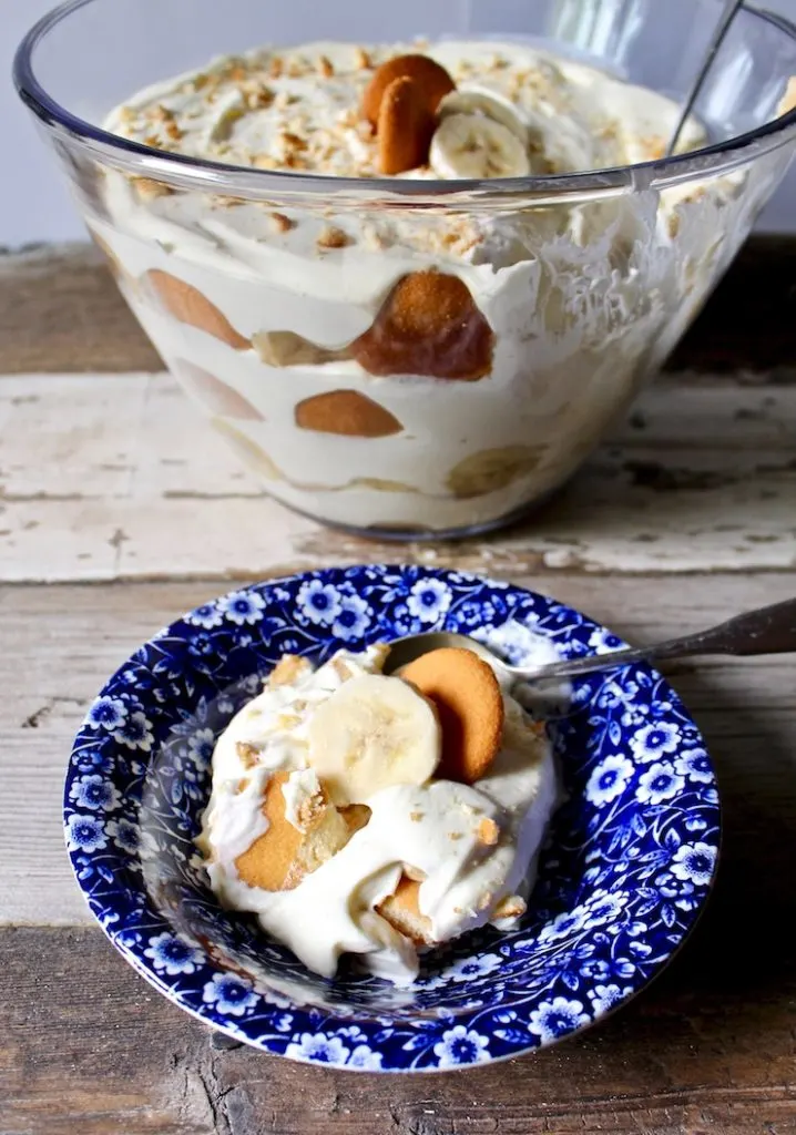 Magnolia Bakery's Famous Banana Pudding, in blue dessert dish with trifle dish in background