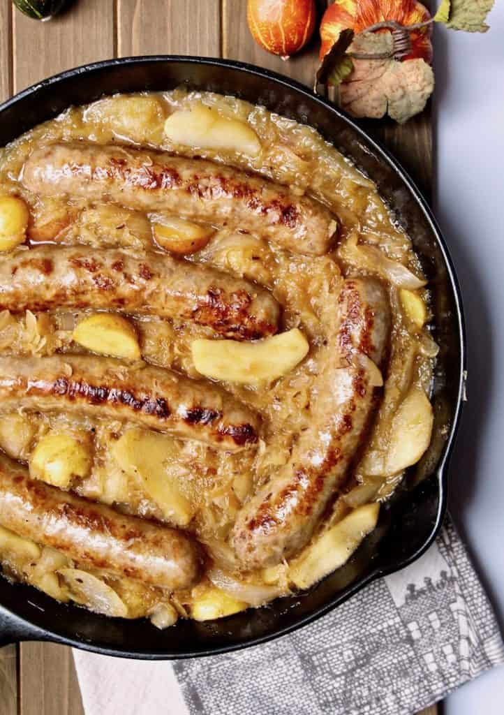 Sausages and sauerkraut in cast iron skillet.