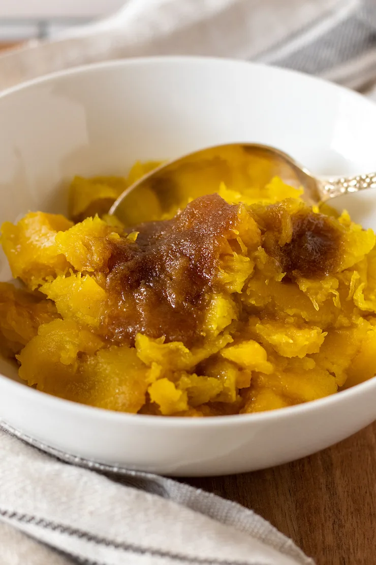 Squash scooped out into serving bowl with spoon.