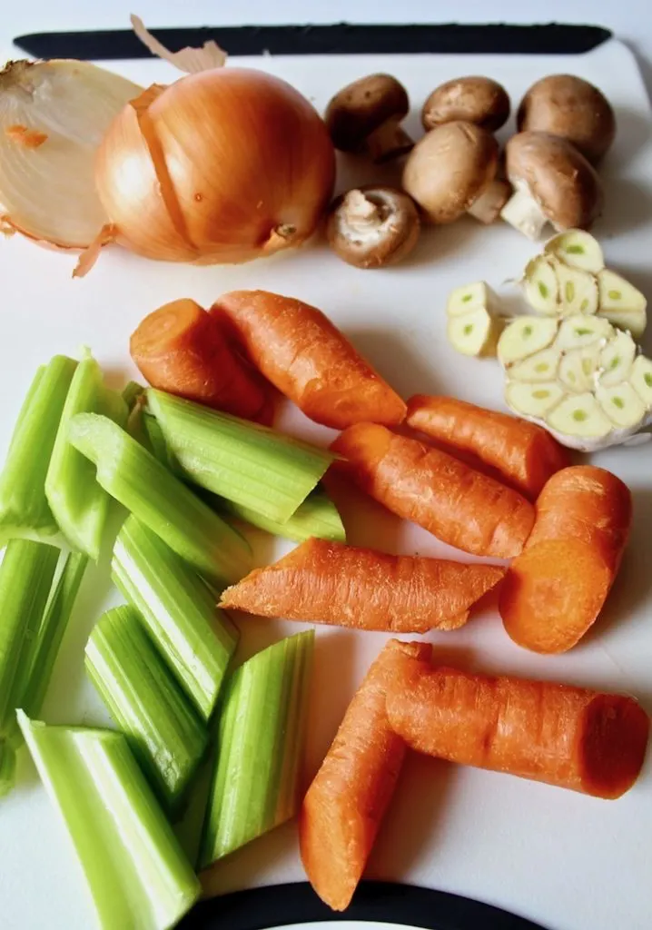 Homemade Turkey Stock, roughly cut up vegetables on cutting board