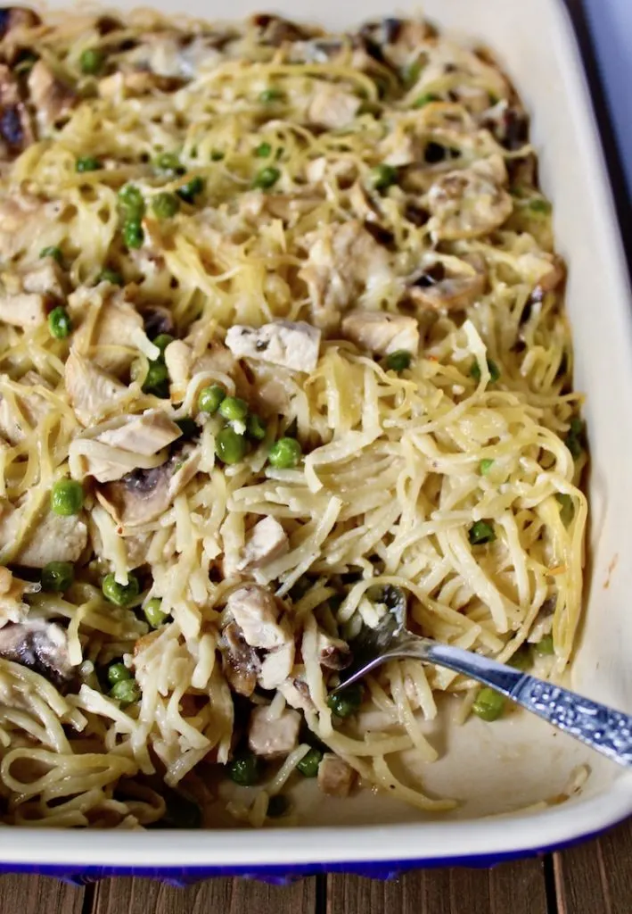 Turkey tetrazzini casserole with serving fork in corner.