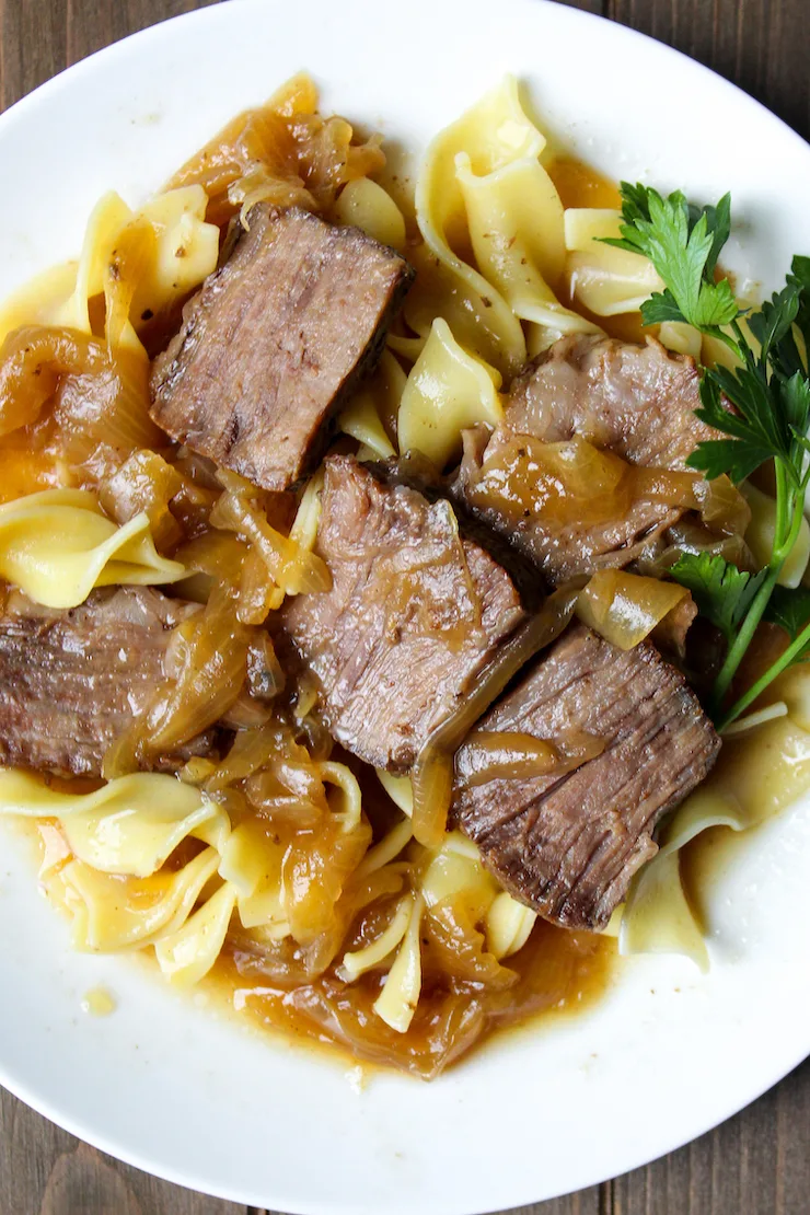 Close up of plated beer braised beef and onions 