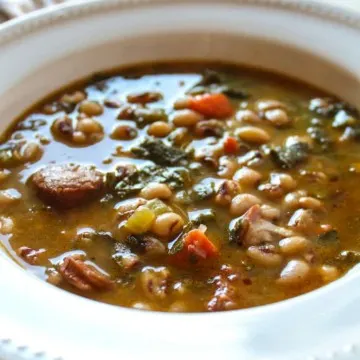 Black eyed pea soup and collard greens in serving bowl.