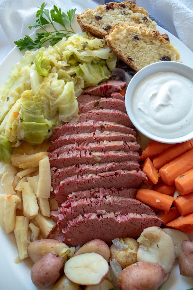 Instant Pot Corned Beef and Cabbage, platter of corned beef, vegetables and cabbage