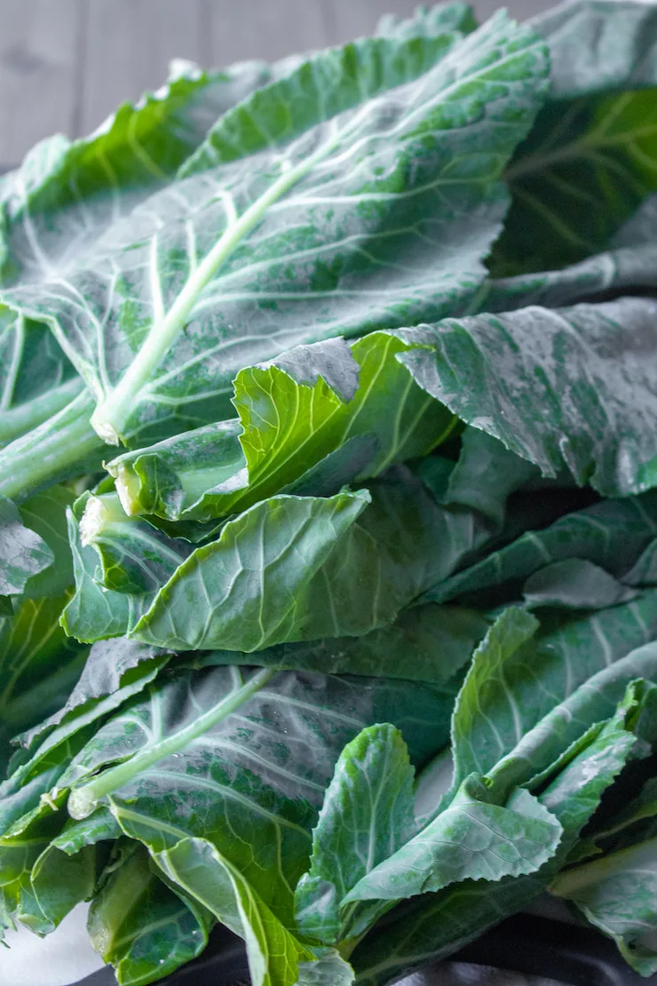 Close up of collard greens on cutting board.