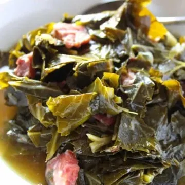 Collards in white serving bowl.