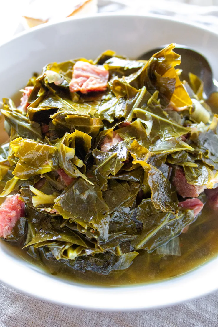 Instant Pot collard greens in white serving bowl.