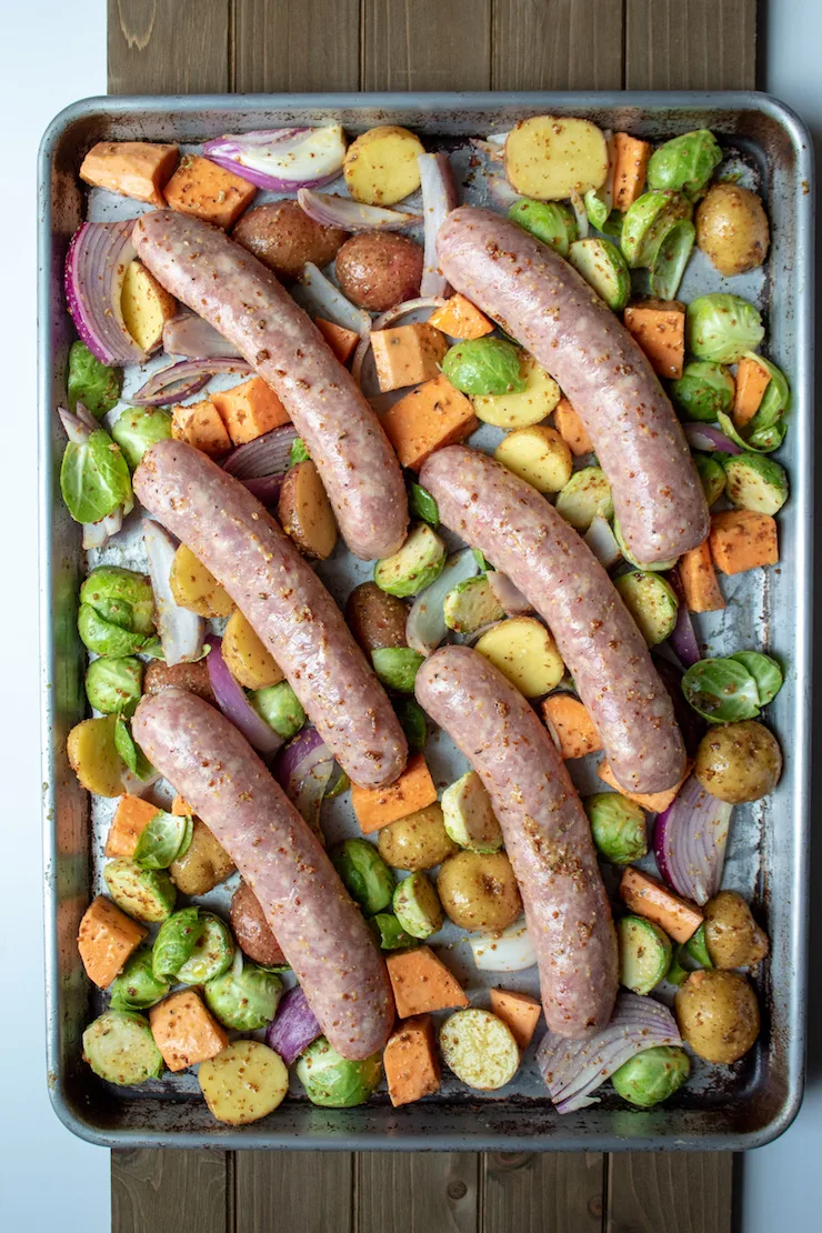 Sausage Sheet Pan Dinner, sausages and vegetables assembled on sheet pan before baking.