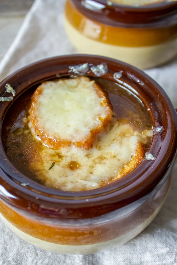 Soup in bowl out of oven with melted cheese.