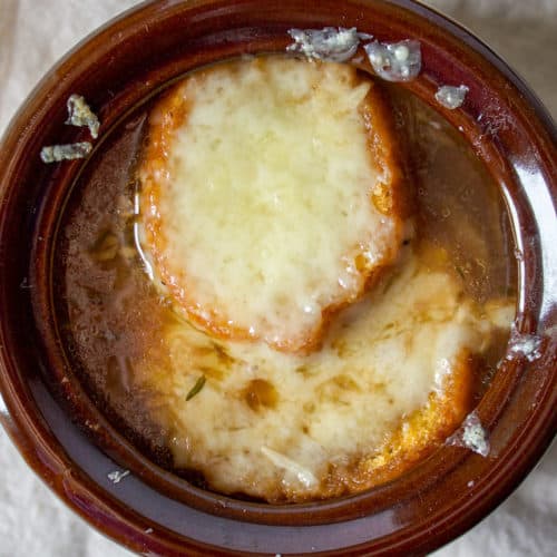 French Onion Soup, close up in oven proof bowl with melted cheese.