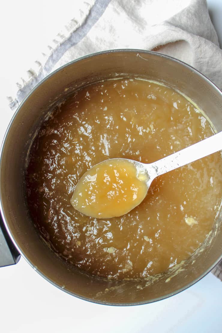 Photo of jellied stock in pot with spoon.