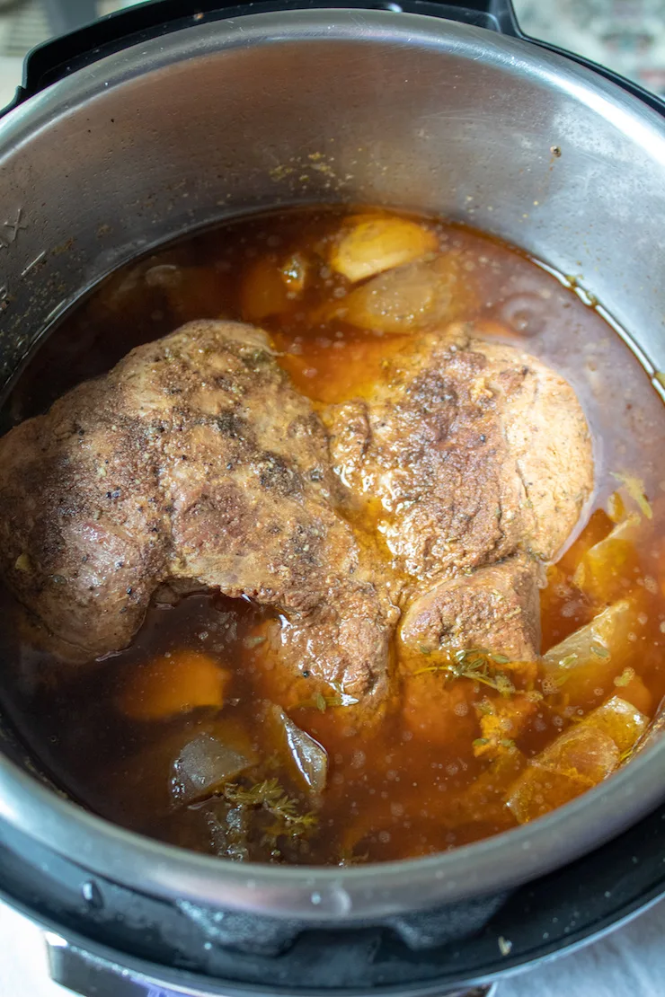 Greek Instant Pot Leg of Lamb, finished lamb in Instant Pot after releasing pressure.