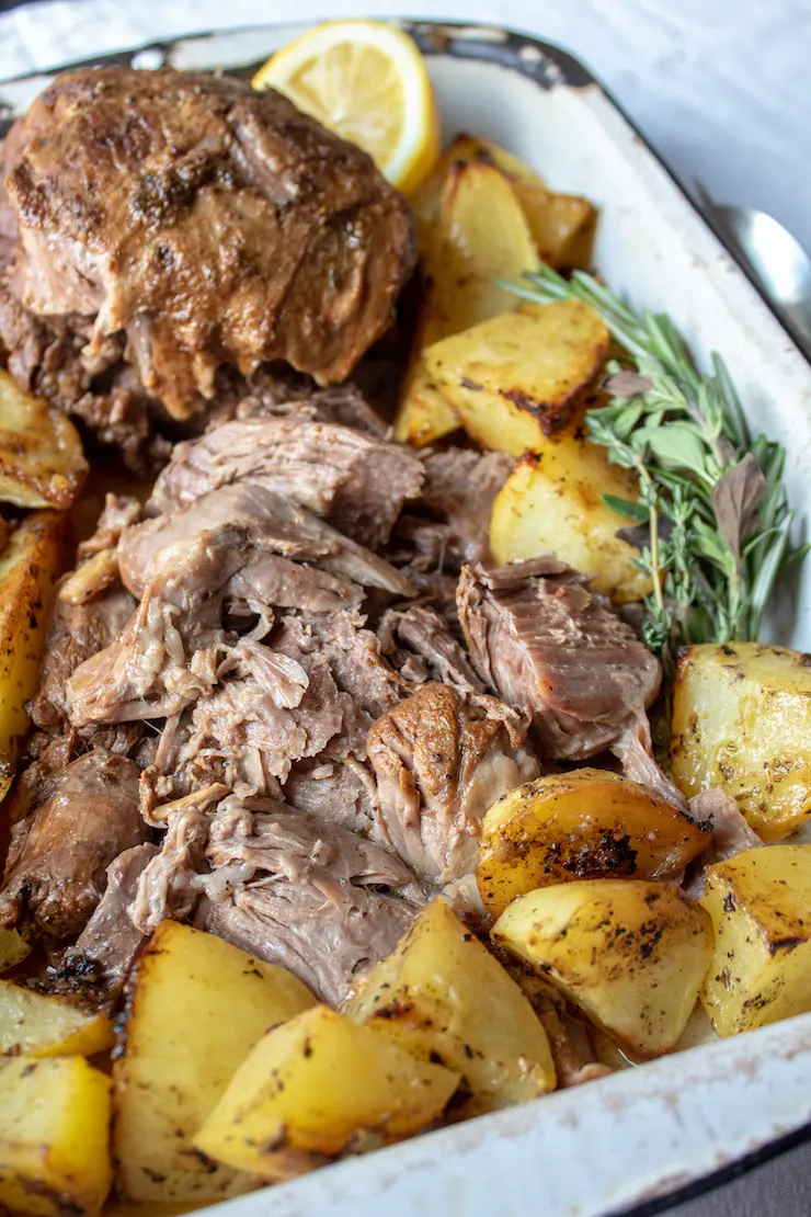 Greek Instant Pot Leg of Lamb, closeup inpan with potatoes.