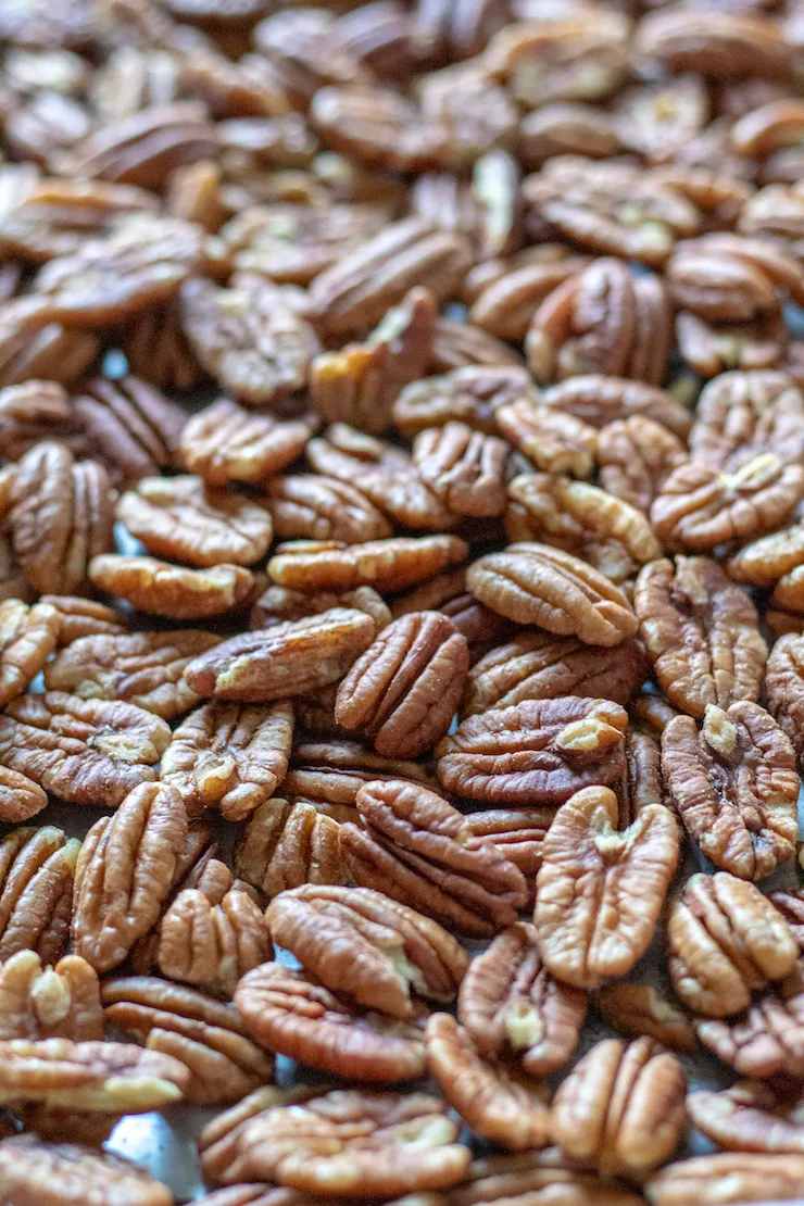 Sheet pan of nuts to toast in oven .