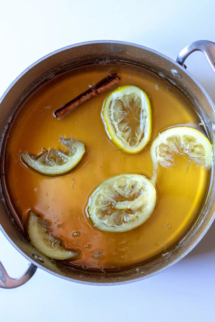 Honey-lemon simple syrup cooling in pan.