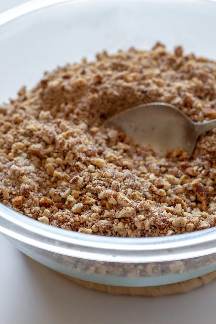 Nut mixture in bowl with spoon.