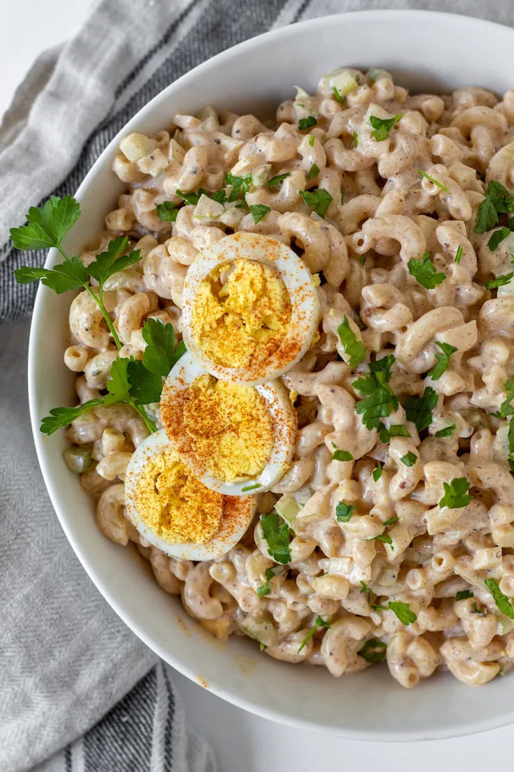 Overhead in serving bowl garnished with hardboiled egg and parsley.