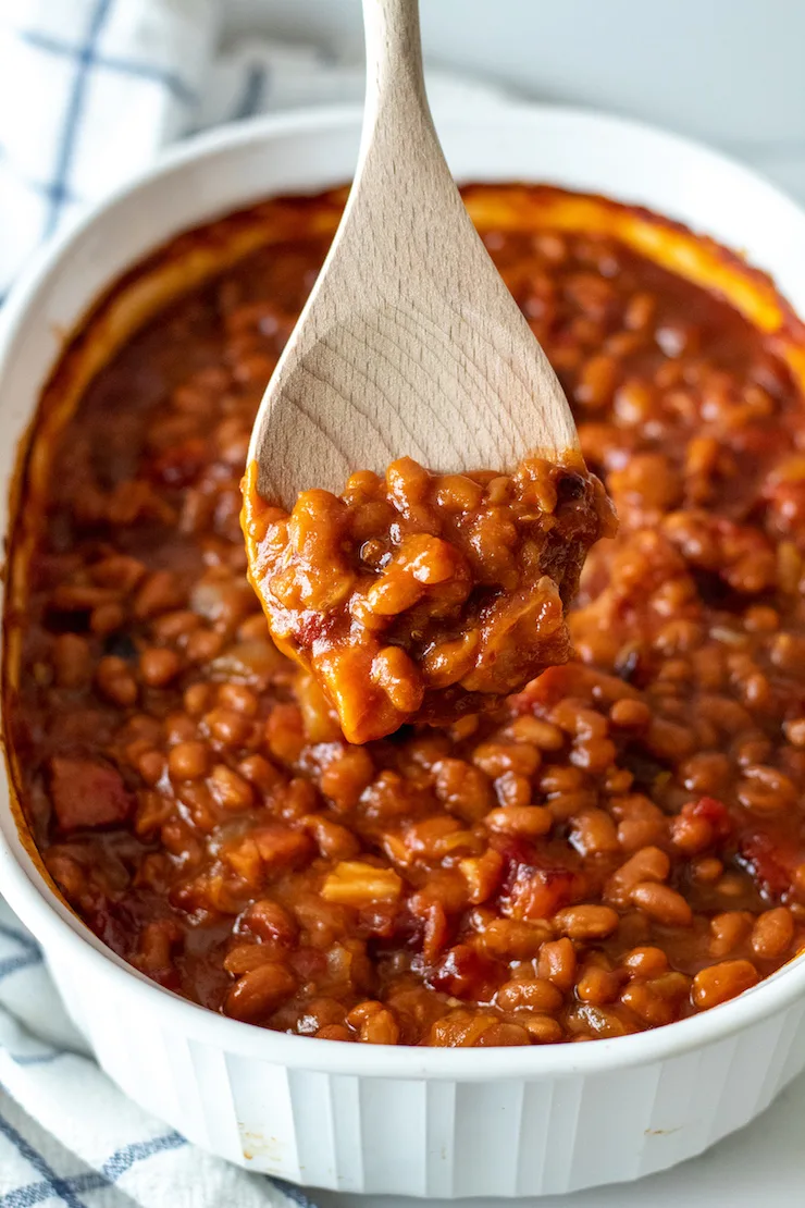Close up of spoonful of baked beans.