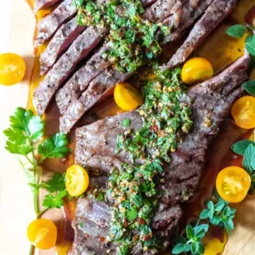 Overhead photo of sliced steak on cutting board.