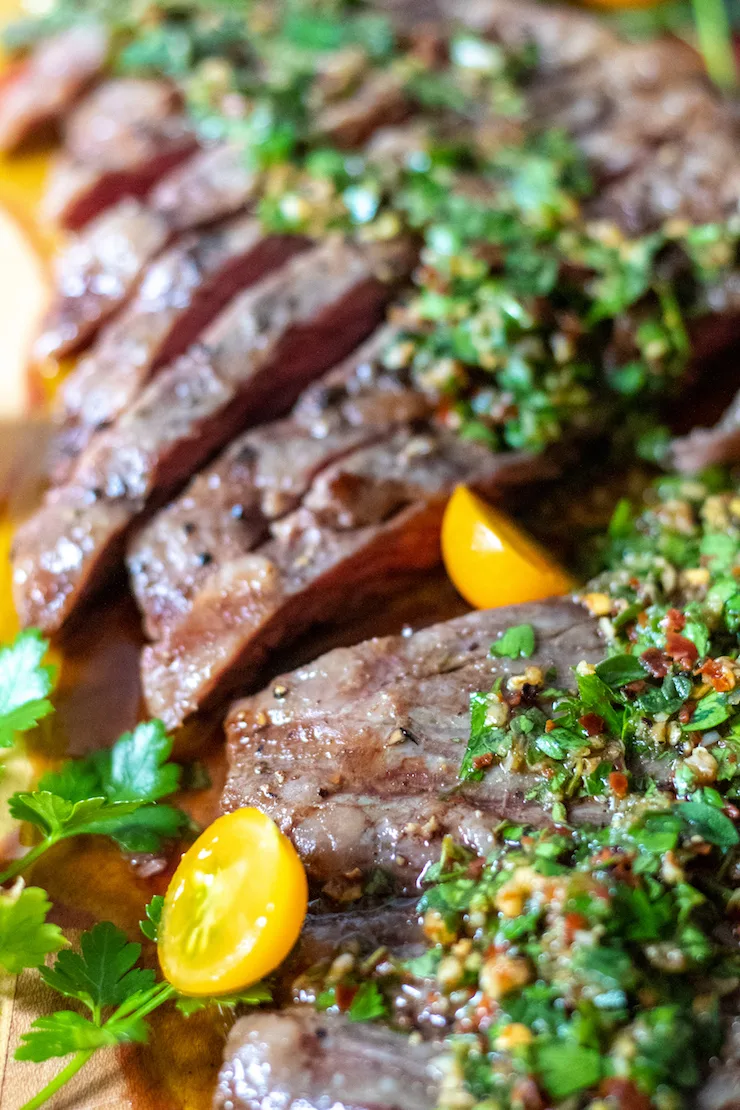 Sliced grilled steak with chimichurri