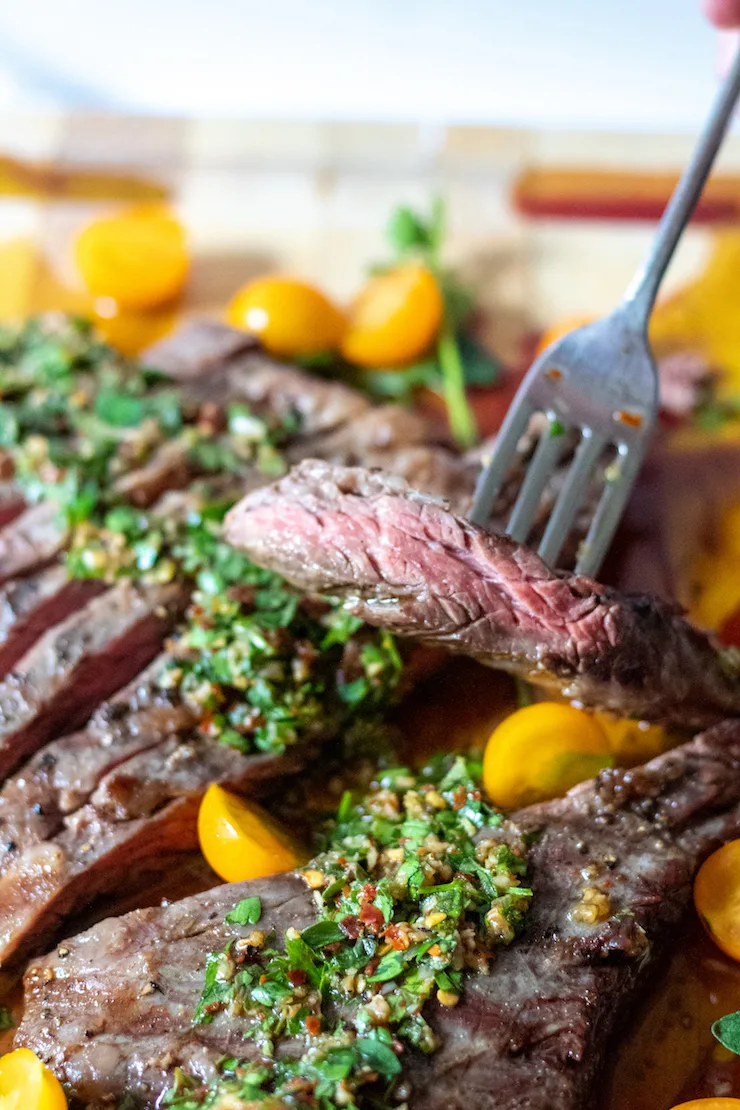 Close up of sliced steak on fork .