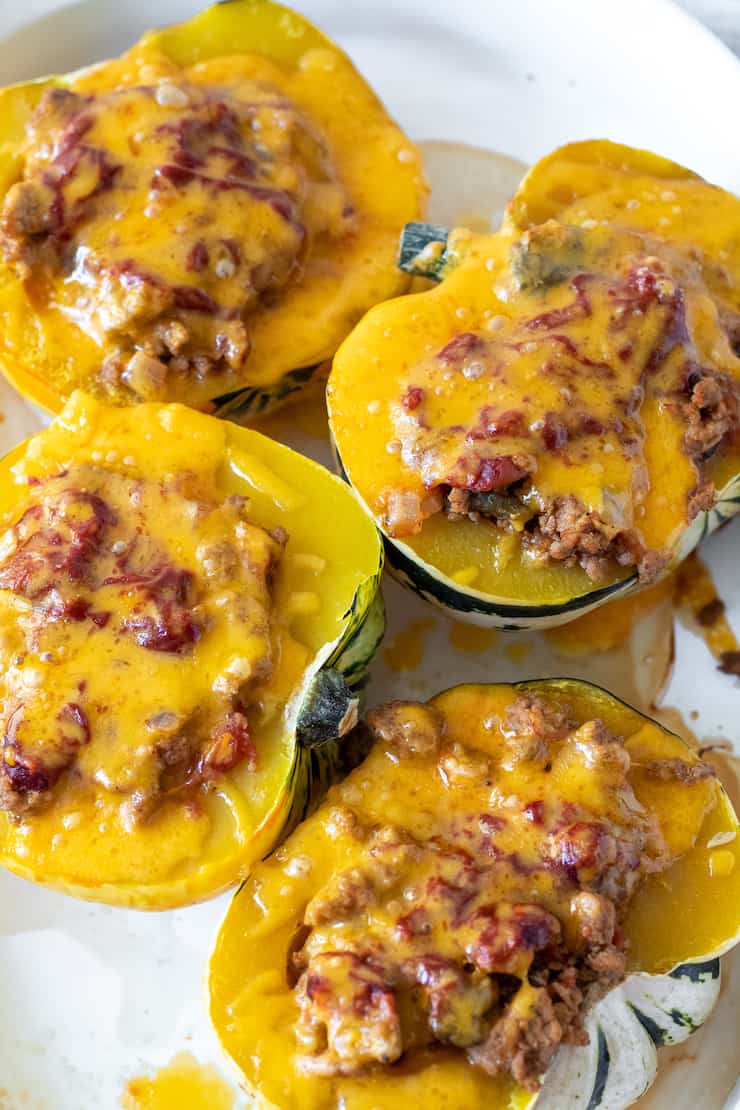 Baked stuffed acorn squash with melted cheese.