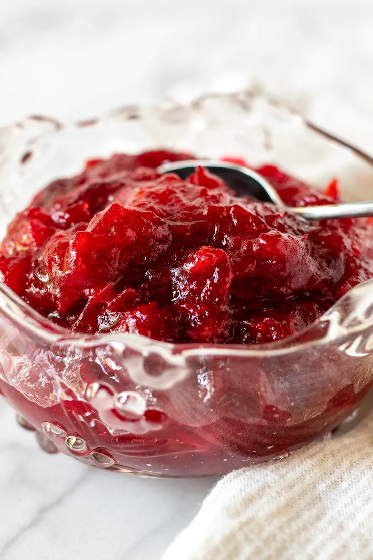 Cranberry orange sauce in a serving dish with spoon.