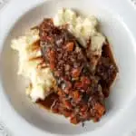 Braised short rib and sauce over mashed potatoes.