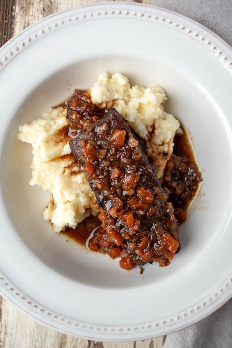 Braised short rib and sauce served over mashed potatoes.