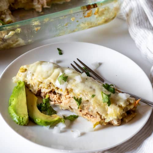 Enchiladas Suizas on serving plate with fork.