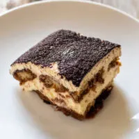 Overhead shot of slice of tiramisu on white plate