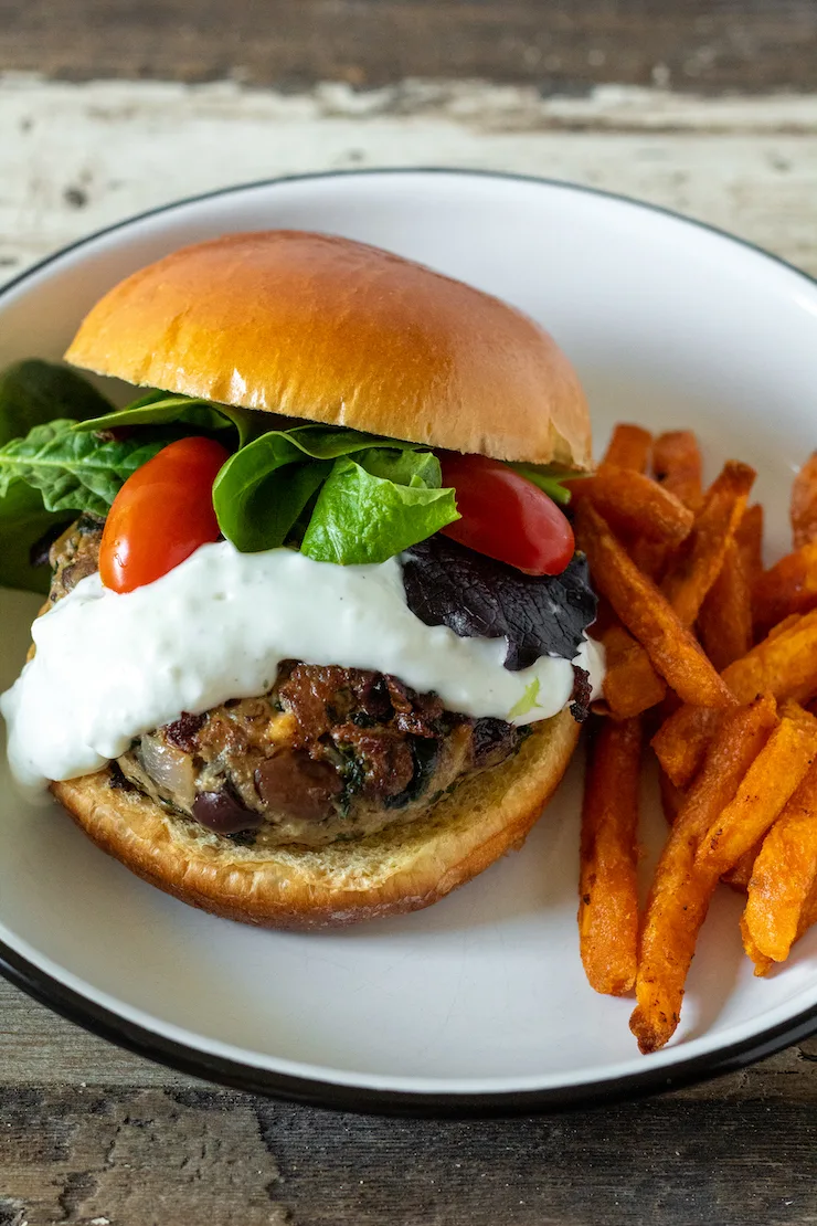 Greek turkey burger with yogaurt sauce and sweet potatoe fries.