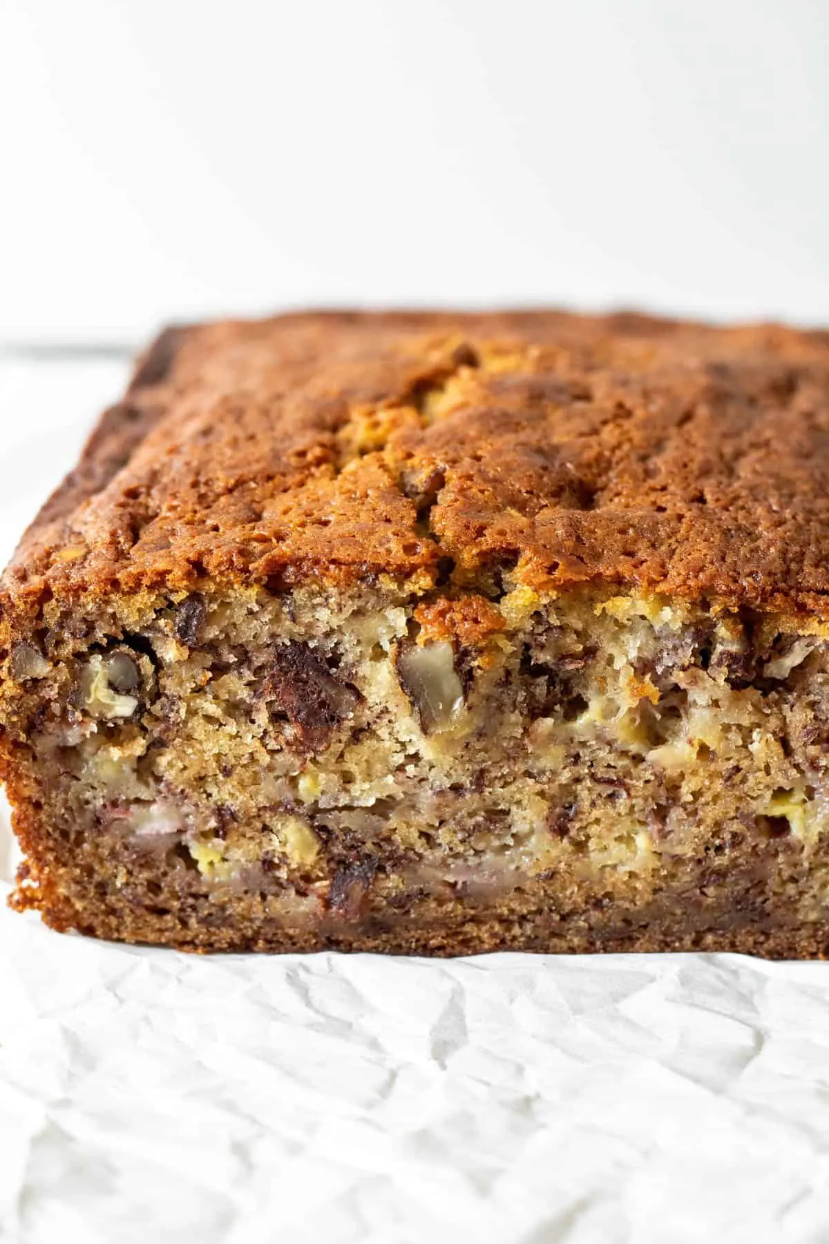 Side view of cut loaf of banana bread showing close up of moist center.